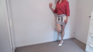 Crossdresser in taut microskirt and tights unveils more