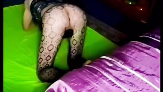 Lil dark-hued  sundress and fishnet tights taunt