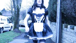 French maid crossdresser outdoors on a council estate