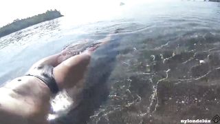 nylondelux in white stocking on the public beach