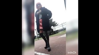 In thight high shoes braless near a active crossroads