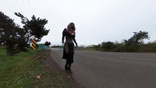 Crossdresser demonstrating on a highway bridge