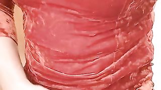 Crossdresser in Orange velvet sundress draining