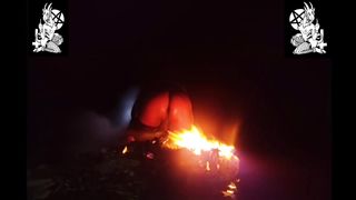 Satanic priestess providing her bum to demon's fire.