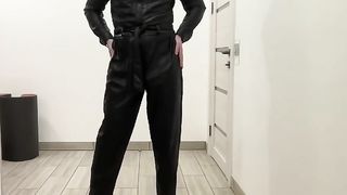 She-Male in a leather jumpsuit romper and high high-heeled shoes SADISM & MASOCHISM