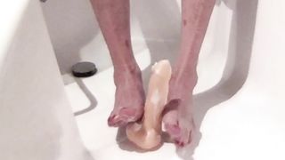 Tgirl vibed, splatters and gives a feetjob