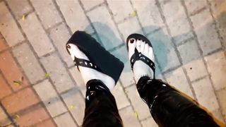 crossdresser on a public street in spandex stretch pants and cool platform roll flops