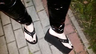 crossdresser on a public street in spandex stretch pants and cool platform roll flops