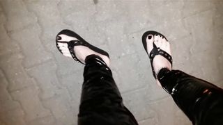 crossdresser on a public street in spandex stretch pants and cool platform roll flops