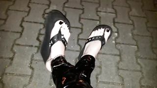 crossdresser on a public street in spandex stretch pants and cool platform roll flops