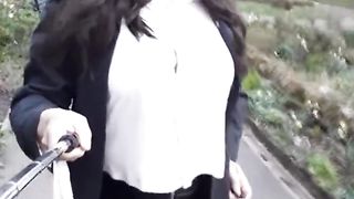 crossdresser dressed in a brief leather miniskirt ambling in the park in Waterfoot Lancashire