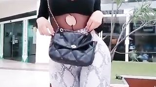 she-male nymph in a public square demonstrating her rump to those who pass assfucking