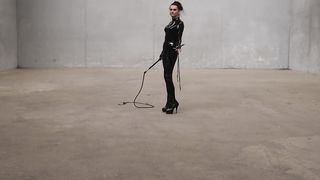 The Queen Obsidian possesses her singletails ominously in her spandex catsuit.