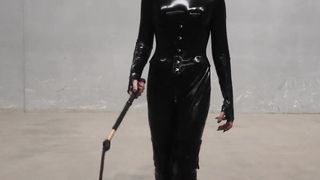 The Queen Obsidian possesses her singletails ominously in her spandex catsuit.