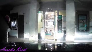 maid clothed under translucent raincoat to cash dipenser