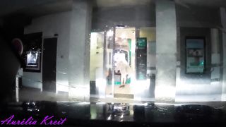 maid clothed under translucent raincoat to cash dipenser