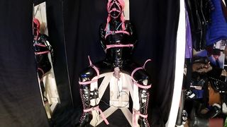 Tied to Pummeling Machine Stool in vinyl Catsuit Ball-Gagged in Virginity