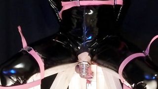 Tied to Pummeling Machine Stool in vinyl Catsuit Ball-Gagged in Virginity