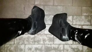 a crossdresser in high ram platform footwear and spandex stretch pants is ambling the streets at night