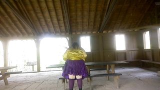 Molly is Dancing in the park while toying soiree music displaying her donk and green silk undies with purple tights