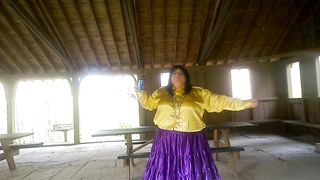 Molly is Dancing in the park while toying soiree music displaying her donk and green silk undies with purple tights