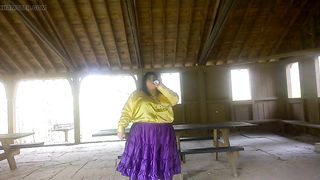 Molly is Dancing in the park while toying soiree music displaying her donk and green silk undies with purple tights