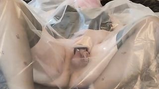 Hooded and encaged sissy crossdresser fulfilling her plastic fetish