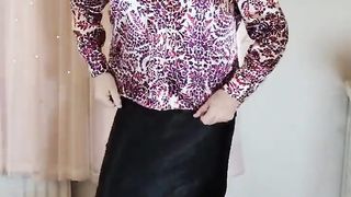 Crossdresser in satin half-top and micro-skirt
