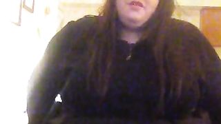 Molly is dressed in her black sundress petting herself showcasing her blue silk undies under her sundress