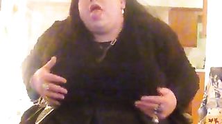 Molly is dressed in her black sundress petting herself showcasing her blue silk undies under her sundress