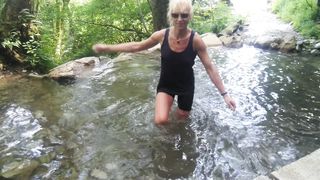 Alexa Cosmic trans doll swimming in font near waterfall dressed in cut-offs and t-tee-shirt...