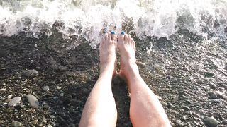 On public beach I sit on the shore dressed in cutoffs and t-t-shirt and drenching my soles in the river ...