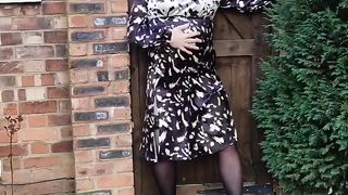Rosy haired crossdresser in spectacular back satin dres