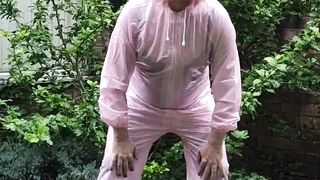 Transgender Princess biotch in pinkish vinyl boiler suit outdoors