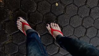 a crossdresser with magnificent soles in spin flops is provocative on the street