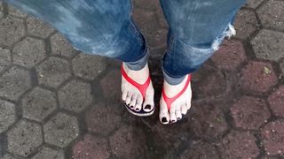 a crossdresser with magnificent soles in spin flops is provocative on the street