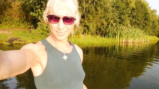Swimming in the lake in fitness wear at sunset.. Moist stretch pants and t-tee-shirt...