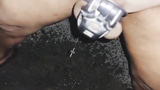 Sissy t-girl ambling bare at night and pee while in encaged and plugged