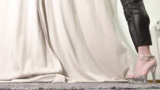 Beautiful trans on platinum high high-heeled slippers and black stretch pants ambling around