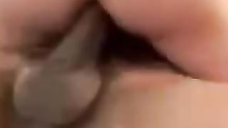 Back glance of Ericka Sprinkle railing a ten inch BIG BLACK COCK with a QOS tat