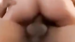 Back glance of Ericka Sprinkle railing a ten inch BIG BLACK COCK with a QOS tat