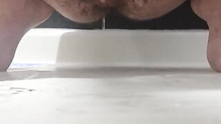 Pulling down sopping trousers and wanking and spraying
