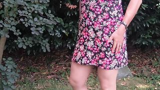 In flowered sundress in the garden