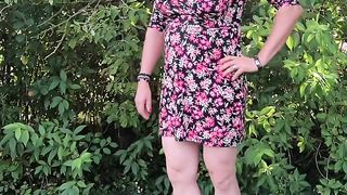 In flowered sundress in the garden