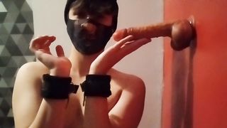 Cuffed femboy deepthroat a fake penis with a v-card box