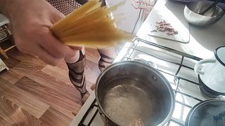 Bare kitchen. Pasta carbonara.