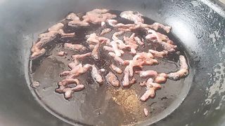 Bare kitchen. Pasta carbonara.