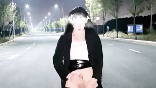 Chinese she-male wanks and finishes off in the middle of the road