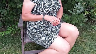 In the garden in naked tights and brief sundress