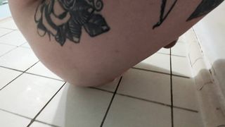 Fatty ladyboy plays with large white faux-cock in shower